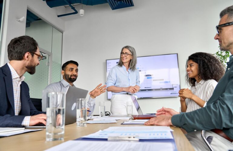 Diverse business leaders and professionals collaborating in a modern office meeting